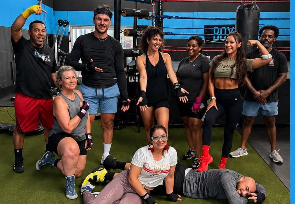 Members and coaches posed together by the ring at Boxing In A Box